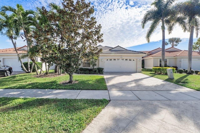 view of front of property with a front yard and a garage