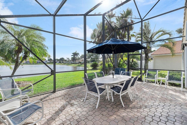 view of patio featuring a water view and a lanai