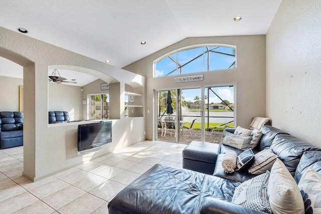 tiled living room with a textured ceiling, ceiling fan, built in features, and lofted ceiling