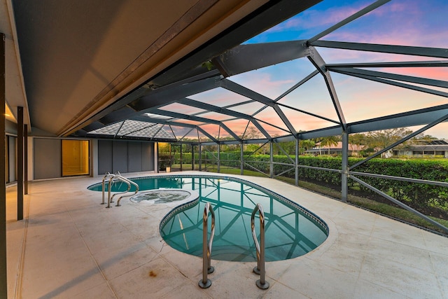 pool at dusk with a patio, a lanai, and a jacuzzi