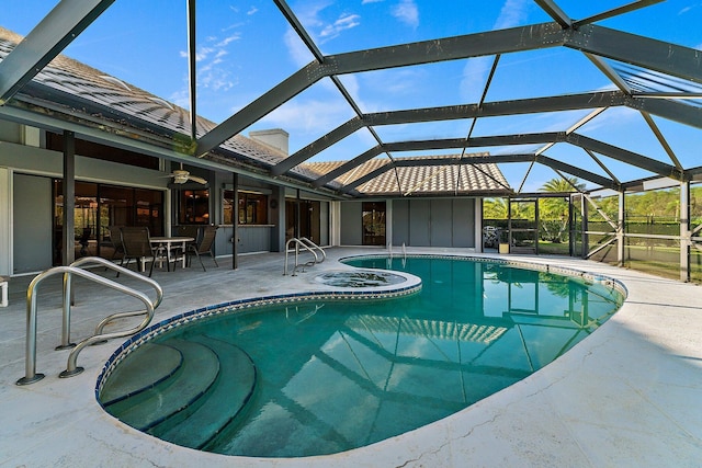 view of swimming pool featuring a patio area and glass enclosure