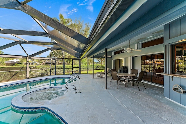 view of swimming pool featuring a lanai and a patio area