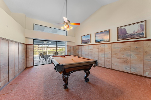 recreation room featuring billiards, ceiling fan, wooden walls, high vaulted ceiling, and carpet