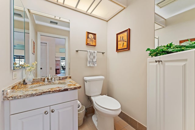 bathroom with vanity, tile patterned flooring, and toilet