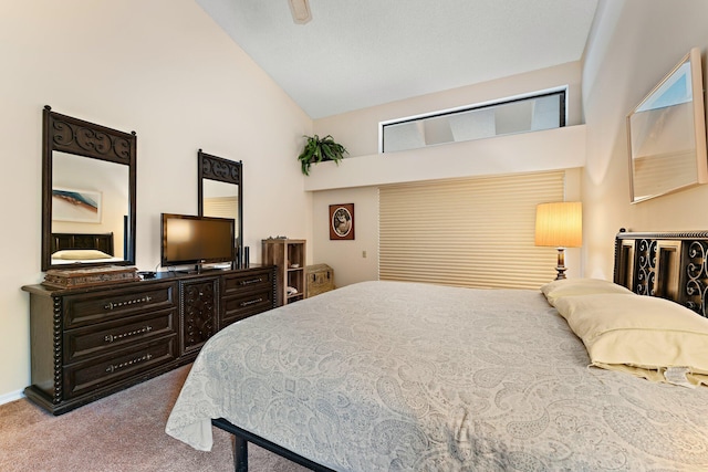 bedroom with carpet floors and high vaulted ceiling