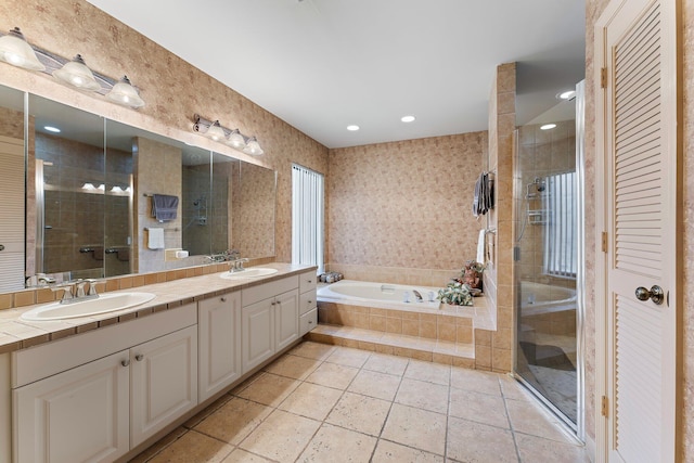 bathroom with vanity and shower with separate bathtub