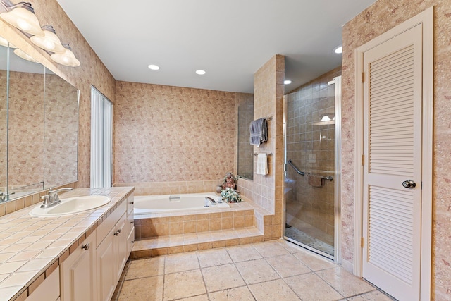 bathroom featuring vanity and shower with separate bathtub