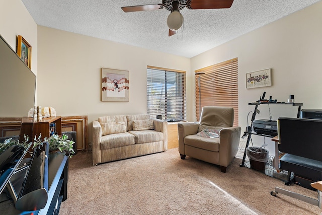 office area with ceiling fan, carpet floors, and a textured ceiling