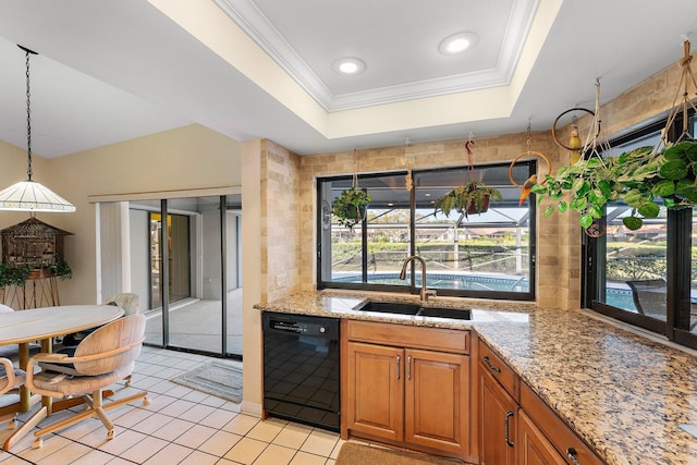 kitchen featuring pendant lighting, black dishwasher, sink, a raised ceiling, and light stone countertops