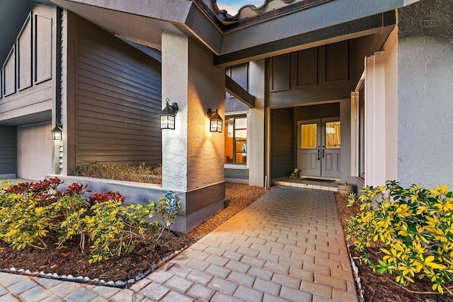 view of exterior entry with a garage