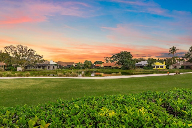 view of community featuring a yard and a water view