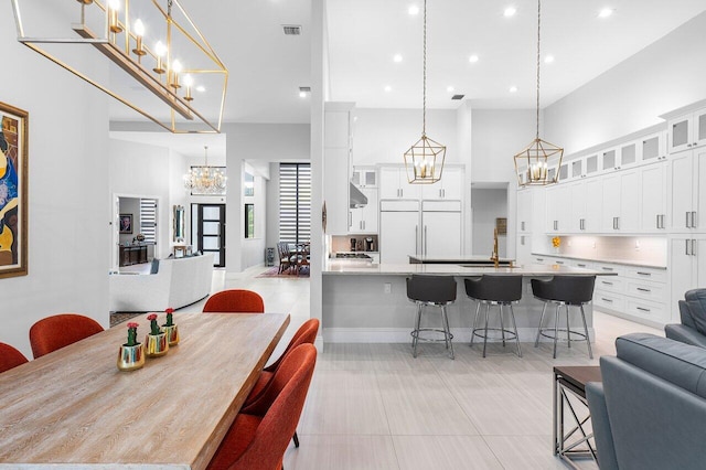 tiled dining area with a towering ceiling