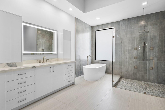 bathroom featuring tile patterned flooring, vanity, and plus walk in shower