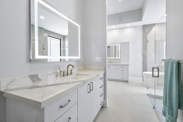 bathroom with vanity, a tub to relax in, and tile patterned floors