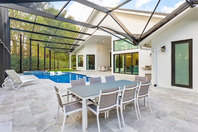 view of pool featuring a lanai, a patio area, and an in ground hot tub