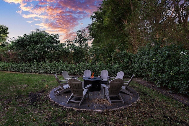 yard at dusk with an outdoor fire pit