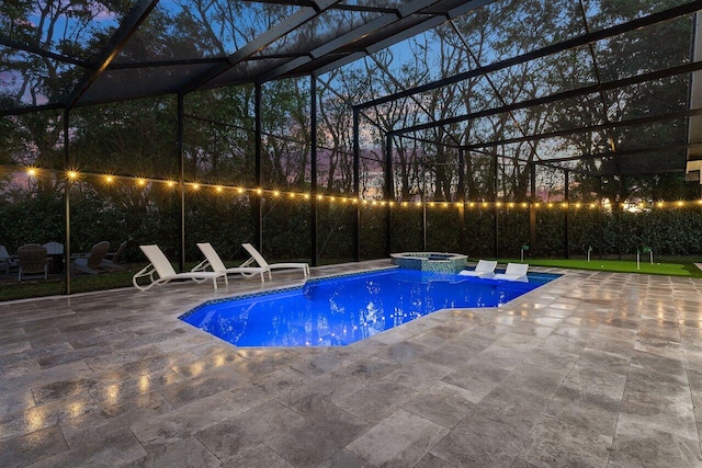 view of pool with a patio area, a lanai, and an in ground hot tub