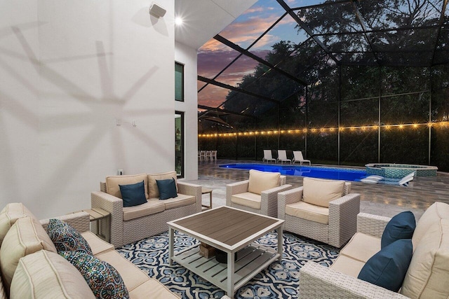 patio terrace at dusk featuring a swimming pool with hot tub, an outdoor hangout area, and glass enclosure