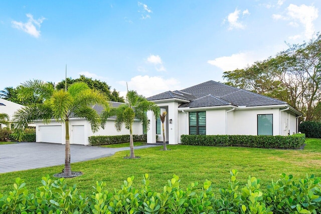 view of front facade with a front yard and a garage