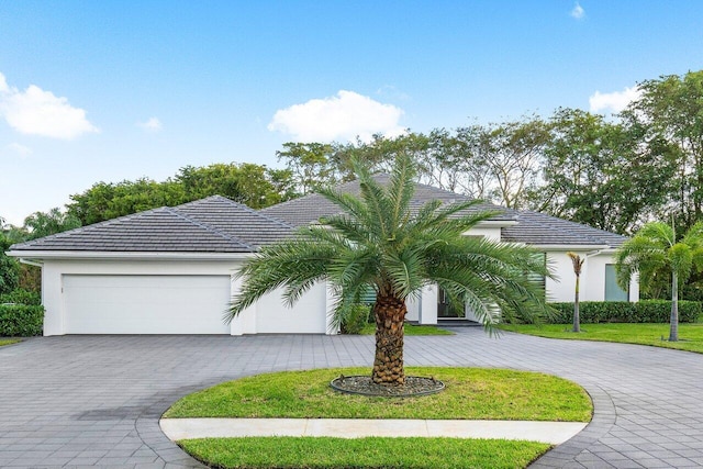 view of front facade with a front lawn and a garage