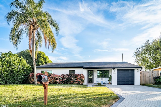 single story home with a front yard and a garage