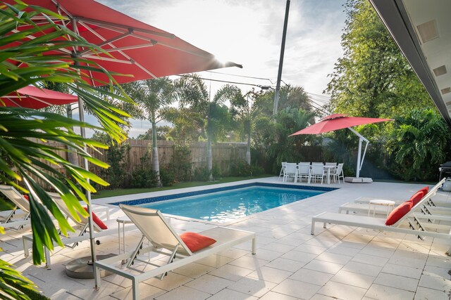 view of swimming pool featuring a patio area