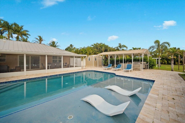 view of swimming pool featuring a sunroom and a patio