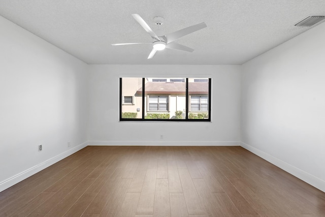 empty room with hardwood / wood-style floors, a textured ceiling, and ceiling fan