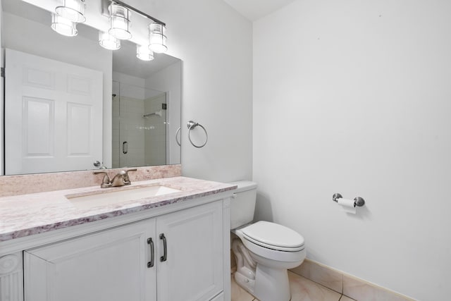 bathroom with a shower with door, vanity, tile patterned floors, and toilet