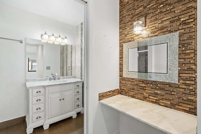 bathroom featuring decorative backsplash, vanity, and wood-type flooring