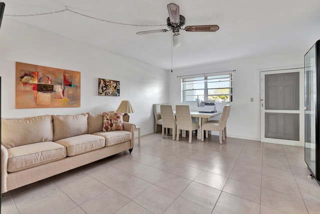 living room featuring ceiling fan and light tile patterned floors