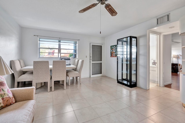 dining space featuring ceiling fan and light tile patterned floors