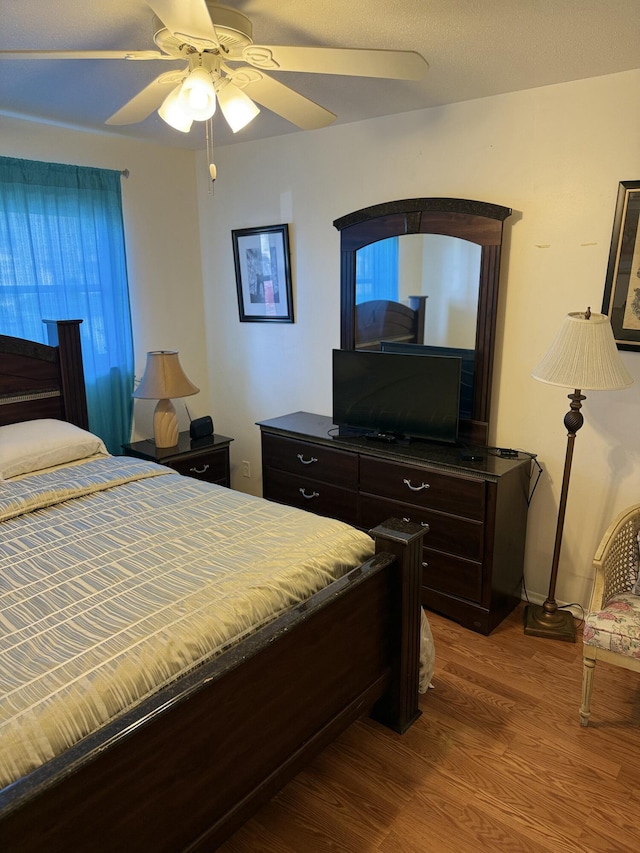 bedroom featuring hardwood / wood-style floors and ceiling fan