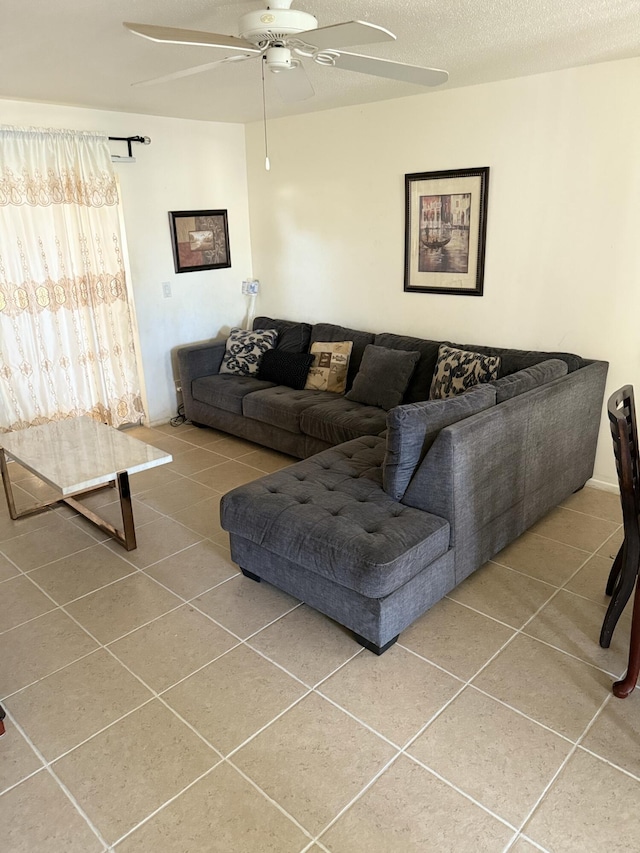 living room with tile patterned flooring, a textured ceiling, and ceiling fan