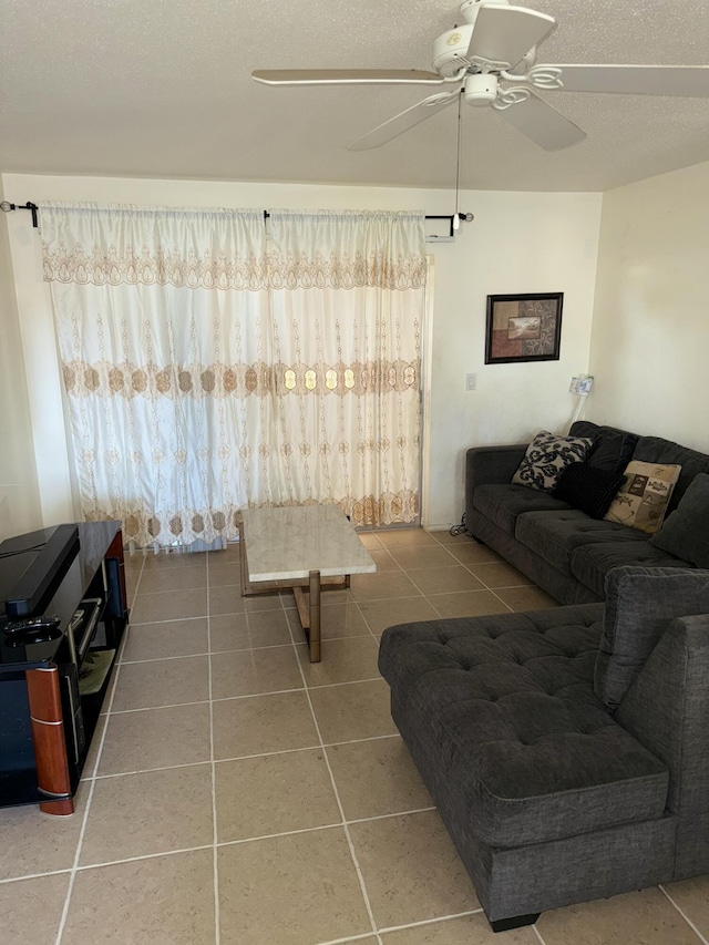 tiled living room featuring a textured ceiling and ceiling fan