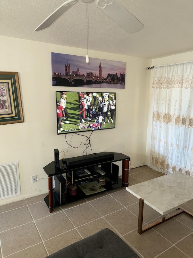 tiled living room featuring a textured ceiling and ceiling fan