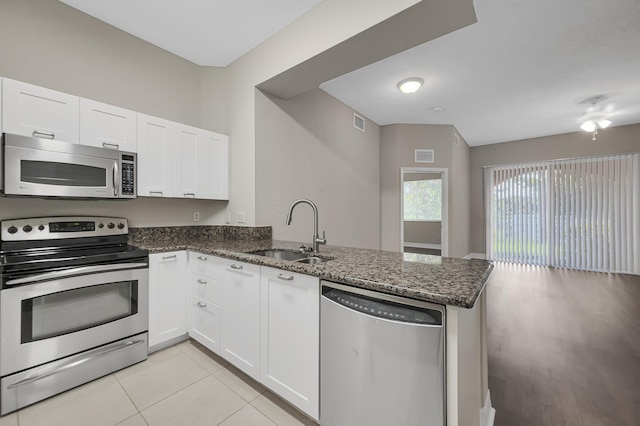 kitchen with white cabinets, kitchen peninsula, sink, and appliances with stainless steel finishes