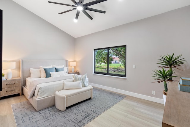 bedroom featuring light hardwood / wood-style floors, high vaulted ceiling, and ceiling fan