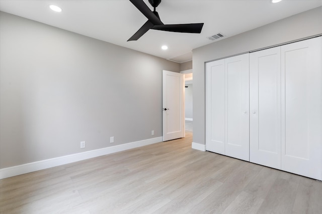 unfurnished bedroom with ceiling fan, a closet, and light wood-type flooring