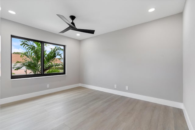 empty room featuring ceiling fan and light hardwood / wood-style flooring