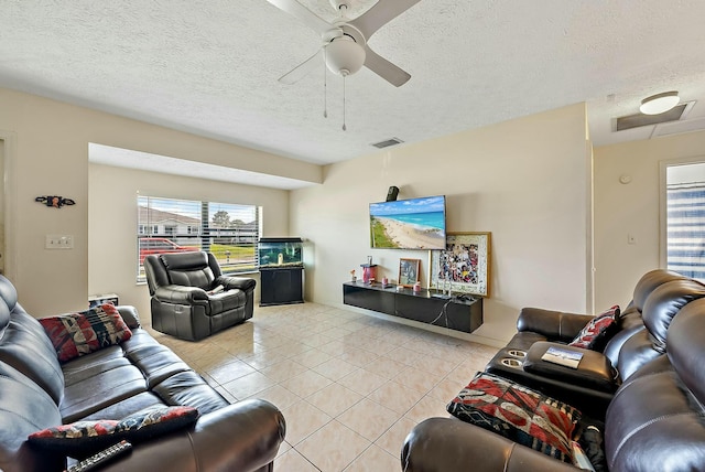 tiled living room with ceiling fan and a textured ceiling