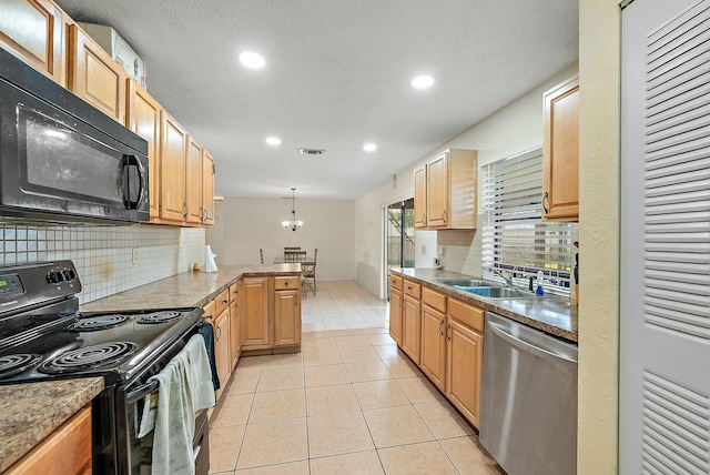 kitchen with kitchen peninsula, sink, black appliances, decorative light fixtures, and light tile patterned flooring