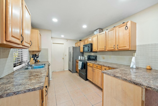 kitchen with light brown cabinetry, tasteful backsplash, sink, black appliances, and light tile patterned floors