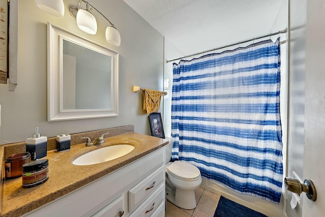 bathroom with walk in shower, tile patterned floors, a textured ceiling, toilet, and vanity