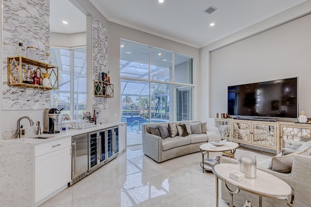 living room featuring crown molding, indoor wet bar, and wine cooler