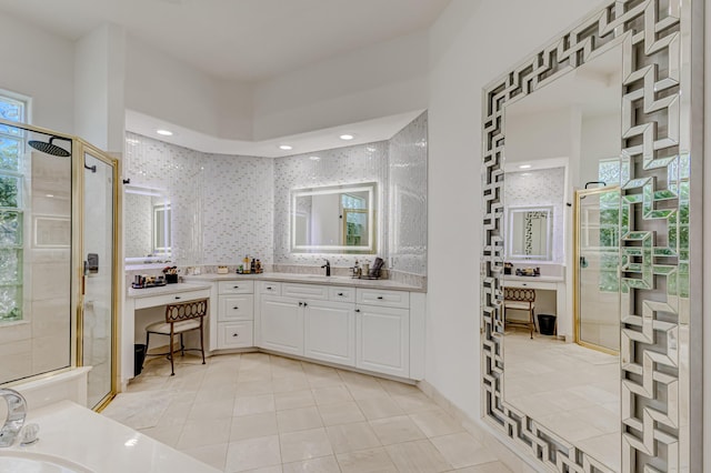 bathroom with vanity, tile patterned floors, and a shower with door