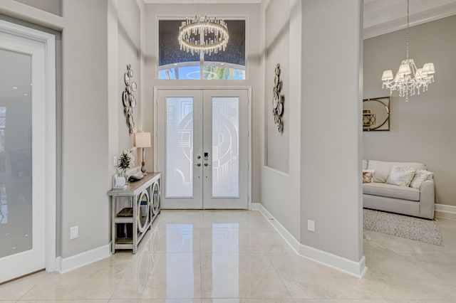 foyer featuring french doors and an inviting chandelier