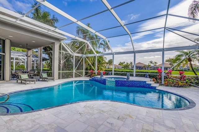 view of swimming pool with glass enclosure, a patio area, and an in ground hot tub