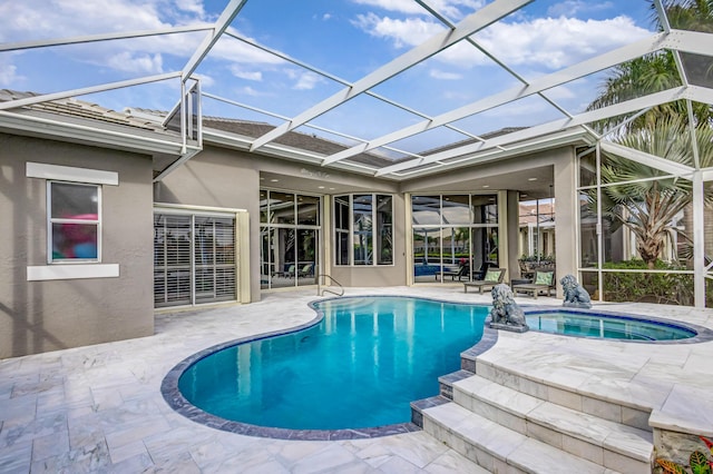 view of pool with a lanai, a patio area, and an in ground hot tub