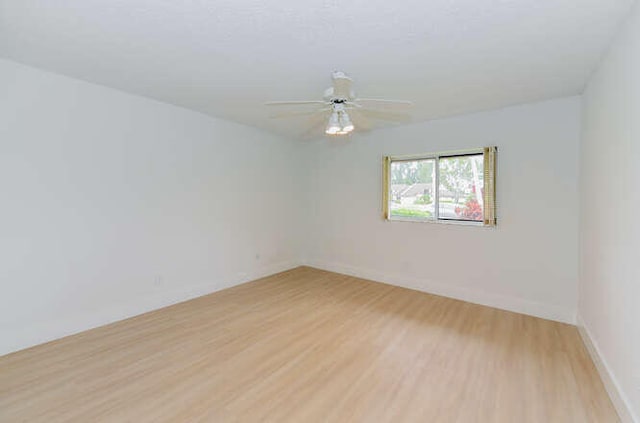 unfurnished room featuring hardwood / wood-style flooring and ceiling fan